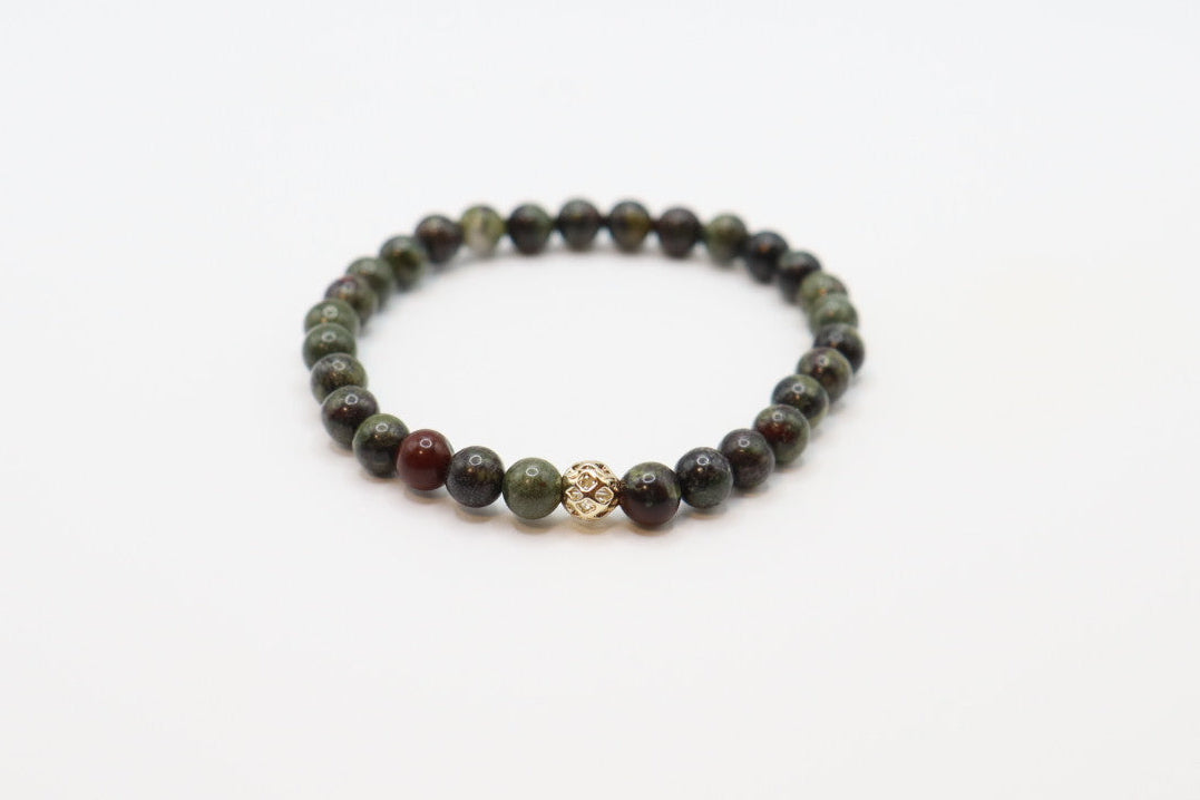 Crafted with striking Dragon Blood Jasper, this bracelet is made for strength, courage, and bold energy.
Known for its grounding and revitalizing properties, this stone is believed to inspire resilience, confidence, and a fierce sense of purpose. Its rich green and red tones make it a standout piece that adds intention and power to any look.
Wear it as a reminder of your inner fire and unstoppable spirit.